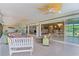 Open sunroom features tile flooring, ceiling fans and view to other rooms at 2077 Vickers Pl, The Villages, FL 32163