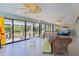 Inviting sunroom with ceiling fans, lots of windows and wicker furniture at 2077 Vickers Pl, The Villages, FL 32163