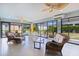 Comfortable sunroom with tile floors, lots of windows and wicker furniture at 2077 Vickers Pl, The Villages, FL 32163