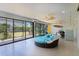 This sunroom offers tile floors, ceiling fans and a round lounge bed at 2077 Vickers Pl, The Villages, FL 32163