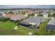 Aerial view of a home with a screened-in lanai, well-manicured yard, and lush landscaping at 2082 Vision Ct, The Villages, FL 32163