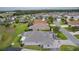 Aerial view of a home in a residential neighborhood featuring well-maintained landscaping and mature trees at 2082 Vision Ct, The Villages, FL 32163
