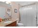 Bathroom with granite countertops, a walk-in shower, and neutral decor at 2082 Vision Ct, The Villages, FL 32163