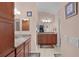 Bathroom with granite countertops, double sinks, and modern fixtures at 2082 Vision Ct, The Villages, FL 32163