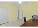 Bright bedroom with tiled floor, closet, and office setup at 2082 Vision Ct, The Villages, FL 32163