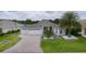 Charming single-story home with a three-car garage, landscaped front yard, and paver driveway at 2082 Vision Ct, The Villages, FL 32163