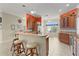 Bright kitchen with a breakfast bar, pendant lighting, and a cozy dining nook with window views at 2082 Vision Ct, The Villages, FL 32163