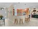 Inviting kitchen features a breakfast bar with seating and seamless flow into the dining area at 2082 Vision Ct, The Villages, FL 32163