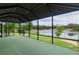 Enclosed lanai with green indoor/outdoor carpet flooring overlooking a beautiful pond at 2082 Vision Ct, The Villages, FL 32163