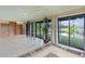 Bright living room with tile floors, built-in bookshelves, a decorative rug and sliding glass doors to the lanai at 2082 Vision Ct, The Villages, FL 32163