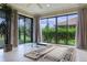 Sunroom featuring tile floors, decorative columns, a rug, and an entrance to the basement below at 2082 Vision Ct, The Villages, FL 32163
