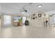 Open-concept living room with tile floors, neutral paint, and a ceiling fan at 2082 Vision Ct, The Villages, FL 32163
