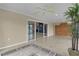 The open-concept sunroom features tiled floors, a ceiling fan, access to the backyard and ample sunlight at 2082 Vision Ct, The Villages, FL 32163