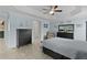 Spacious main bedroom with light blue walls, tile flooring, and comfortable seating area at 2082 Vision Ct, The Villages, FL 32163