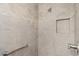 Walk-in shower featuring custom tile work, a built-in niche, and a grab bar at 2082 Vision Ct, The Villages, FL 32163