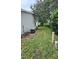 Side yard area with air conditioning unit and well-maintained lawn at 2105 Escobar Ave, The Villages, FL 32159