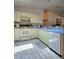 Well-lit kitchen with blue countertops, white appliances, and ample cabinet space at 2105 Escobar Ave, The Villages, FL 32159