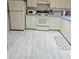 Functional kitchen features white appliances and light-colored cabinets at 2105 Escobar Ave, The Villages, FL 32159