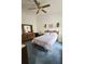 Inviting bedroom with a ceiling fan, dresser, and comfortable bed at 2105 Escobar Ave, The Villages, FL 32159