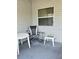Screened porch with seating area and outside window at 2105 Escobar Ave, The Villages, FL 32159