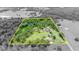 Aerial view with a yellow border of the property showing house, buildings, pond and trees at 21320 Paradise Way, Eustis, FL 32736