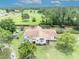 Expansive aerial view of home featuring a large lawn, mature trees, and fenced yard at 21320 Paradise Way, Eustis, FL 32736