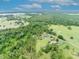 Scenic aerial view of the property and surrounding farmland at 21320 Paradise Way, Eustis, FL 32736