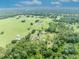 Expansive aerial view showcases the home, barn, and surrounding acreage at 21320 Paradise Way, Eustis, FL 32736