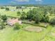 Aerial view of the home, kennels, and surrounding land at 21320 Paradise Way, Eustis, FL 32736