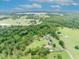 Expansive aerial view showcases the home, barn, and surrounding acreage at 21320 Paradise Way, Eustis, FL 32736