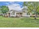 A charming home with a large backyard and mature trees provides a serene outdoor living space at 21320 Paradise Way, Eustis, FL 32736