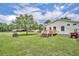Backyard showcasing back deck, well, home, and a red ATV at 21320 Paradise Way, Eustis, FL 32736