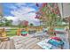 Inviting backyard deck with play area, and a view of a well maintained lawn at 21320 Paradise Way, Eustis, FL 32736