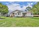 A charming home with a large backyard and mature trees provides a serene outdoor living space at 21320 Paradise Way, Eustis, FL 32736