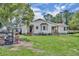 A charming home with a large backyard and mature trees provides a serene outdoor living space at 21320 Paradise Way, Eustis, FL 32736