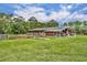 Barn showcasing open stalls, storage, and attached shed at 21320 Paradise Way, Eustis, FL 32736