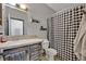 Bathroom featuring a shower with a checkered curtain and a wooden vanity at 21320 Paradise Way, Eustis, FL 32736
