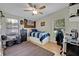 Cozy bedroom with ceiling fan, natural light, and wood floor at 21320 Paradise Way, Eustis, FL 32736