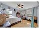 Bedroom featuring hardwood floors, an overhead fan, and two windows at 21320 Paradise Way, Eustis, FL 32736
