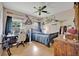 Comfortable bedroom featuring a ceiling fan and wood flooring at 21320 Paradise Way, Eustis, FL 32736