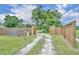 Long driveway with wooden gate and fenced yard at 21320 Paradise Way, Eustis, FL 32736