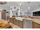 Bright kitchen with a farmhouse sink, stainless dishwasher, and view to the dining and living areas at 21320 Paradise Way, Eustis, FL 32736