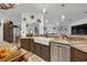 The kitchen features an island, tile flooring, stainless appliances, and earth tone cabinetry at 21320 Paradise Way, Eustis, FL 32736