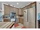 The neutral kitchen features granite counters, a microwave and stainless steel appliances at 21320 Paradise Way, Eustis, FL 32736