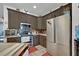 A well lit spacious kitchen features stainless appliances and dark earth tone cabinetry at 21320 Paradise Way, Eustis, FL 32736