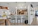 Kitchen bar with unique wheel-backed stools and pendant lighting overlooks the kitchen at 21320 Paradise Way, Eustis, FL 32736