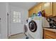 Laundry room with washer and dryer hookups, a tiled floor, and backyard access at 21320 Paradise Way, Eustis, FL 32736