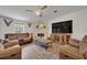 Inviting living room showcases a stone fireplace, a large tv and comfortable seating at 21320 Paradise Way, Eustis, FL 32736
