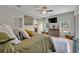 A main bedroom suite with a barn door to the main bathroom and view to the front yard at 21320 Paradise Way, Eustis, FL 32736