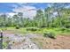 Tranquil pond located on a large green lot with lush landscaping at 21320 Paradise Way, Eustis, FL 32736